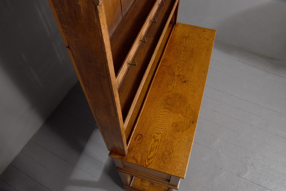 A George III two-part oak dresser featuring an open three-shelf plate rack with iron hooks above two drawers and an open potboard base. View II
