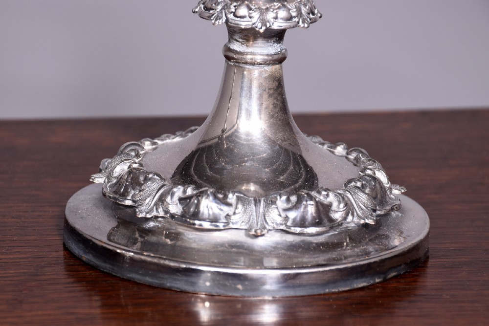 A pair of antique silver-plated three-light candelabra featuring circular bases, baluster stems, and curved reeded branches. View II
