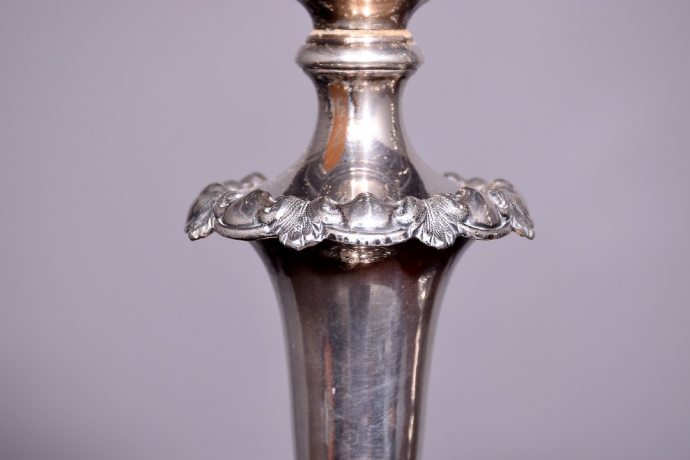 A pair of antique silver-plated three-light candelabra featuring circular bases, baluster stems, and curved reeded branches. View IV