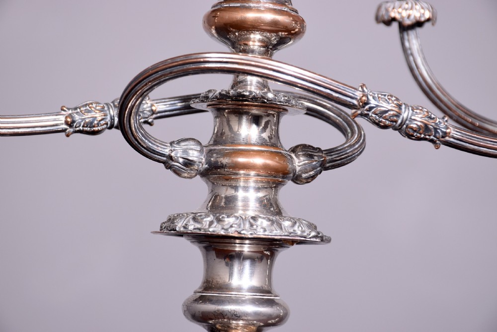 A pair of antique silver-plated three-light candelabra featuring circular bases, baluster stems, and curved reeded branches. View VII