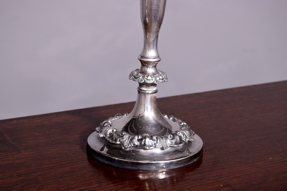 A pair of antique silver-plated three-light candelabra featuring circular bases, baluster stems, and curved reeded branches. View VIII