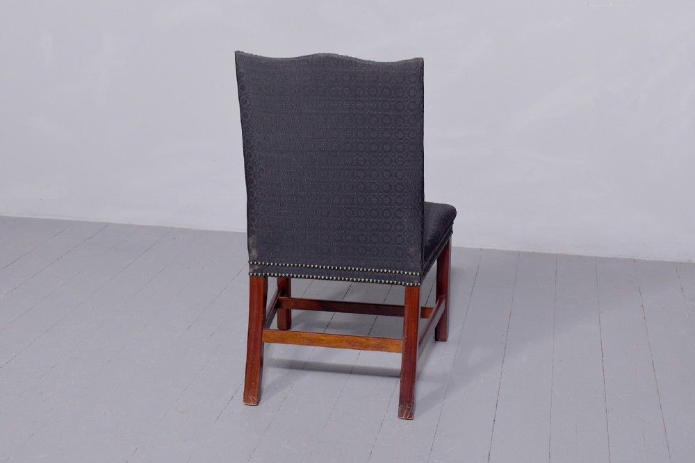 A set of four George III style side chairs upholstered in dark grey patterned fabric with brass stud trimming and straight mahogany legs. View II
