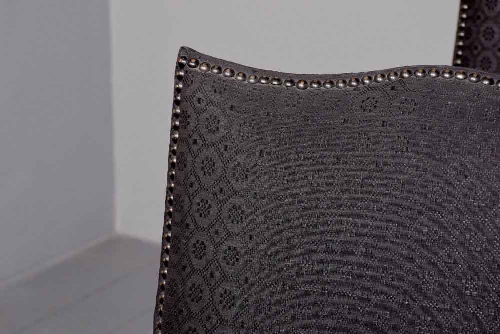 A set of four George III style side chairs upholstered in dark grey patterned fabric with brass stud trimming and straight mahogany legs. View VI