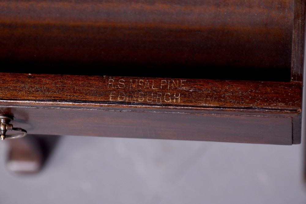 A tall, narrow mahogany side table featuring four straight legs, a single drawer with a central brass ring pull, and a polished wood surface. View V