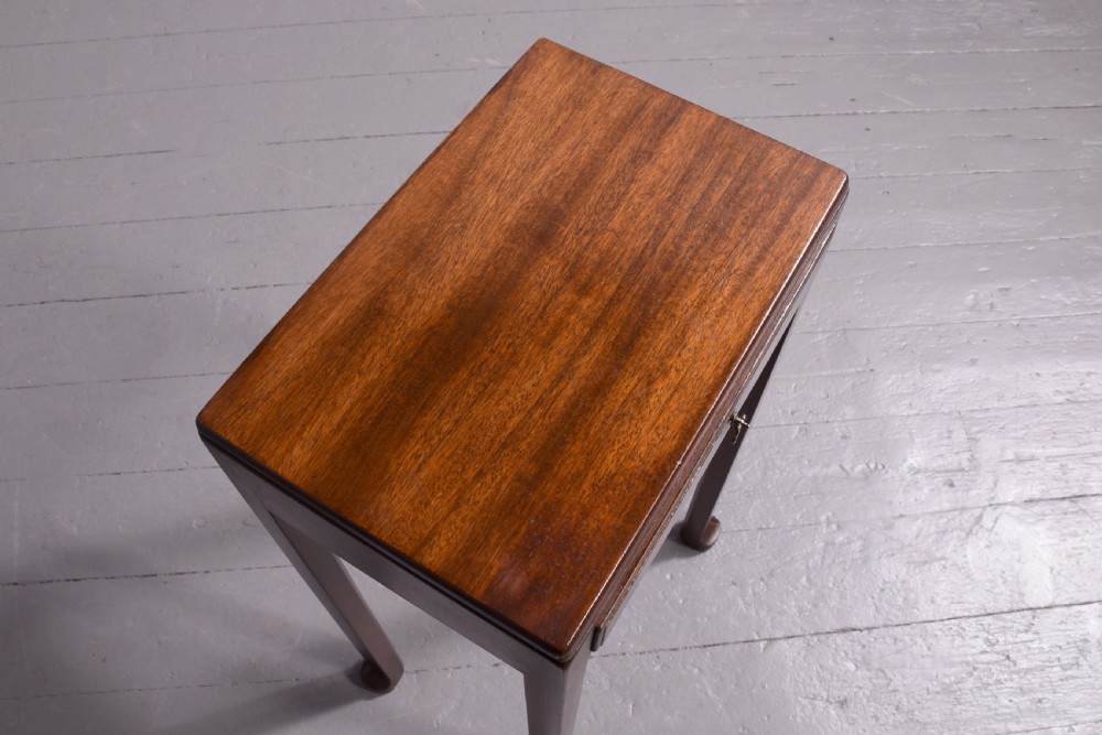A tall, narrow mahogany side table featuring four straight legs, a single drawer with a central brass ring pull, and a polished wood surface. View VI