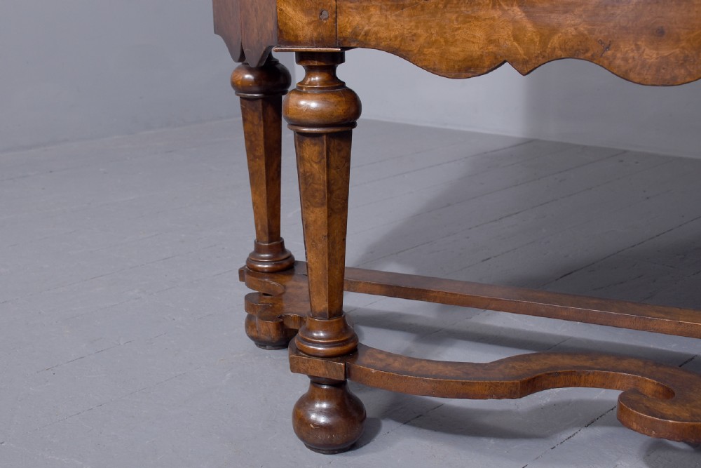 A nineteenth-century Dutch burr walnut display cabinet featuring canted glazed sides, an arched cresting cornice, two lower drawers, and turned legs connected by a shaped stretcher. View IV