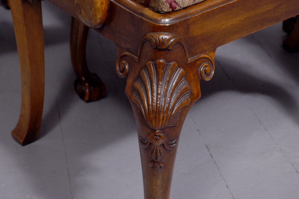 A set of George II style carved walnut dining chairs featuring pierced back splats, cabriole legs with claw and ball feet, and patterned upholstered seats. View VI