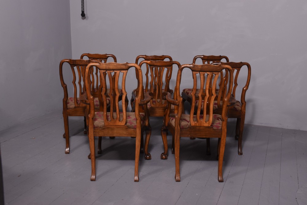 A set of George II style carved walnut dining chairs featuring pierced back splats, cabriole legs with claw and ball feet, and patterned upholstered seats. View VII