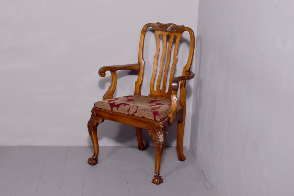 A set of George II style carved walnut dining chairs featuring pierced back splats, cabriole legs with claw and ball feet, and patterned upholstered seats. View VIII