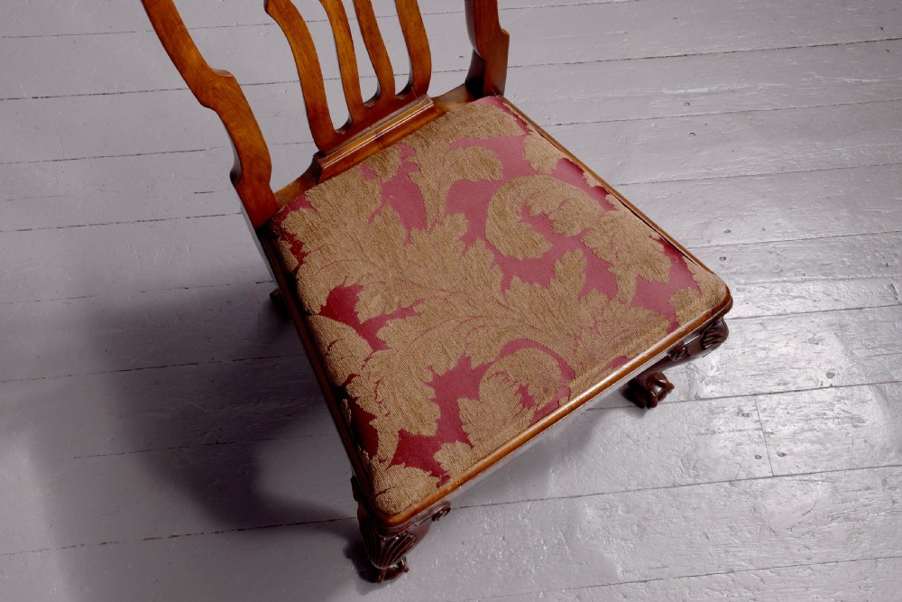 A set of George II style carved walnut dining chairs featuring pierced back splats, cabriole legs with claw and ball feet, and patterned upholstered seats. View XI