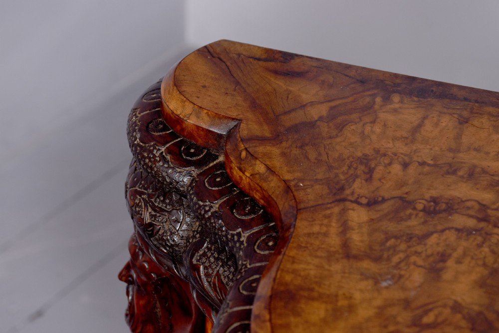 A mid-Victorian burr walnut serpentine-fronted credenza featuring carved female figure pilasters, central mirrored doors, and curved glass side display cabinets. View VII