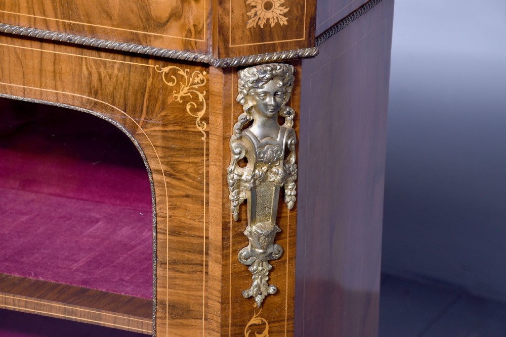 A Victorian figured walnut cabinet featuring twin glazed doors, intricate marquetry floral inlay along the frieze, gilt bronze mounts, and a red fabric-lined interior with three shelves. View II