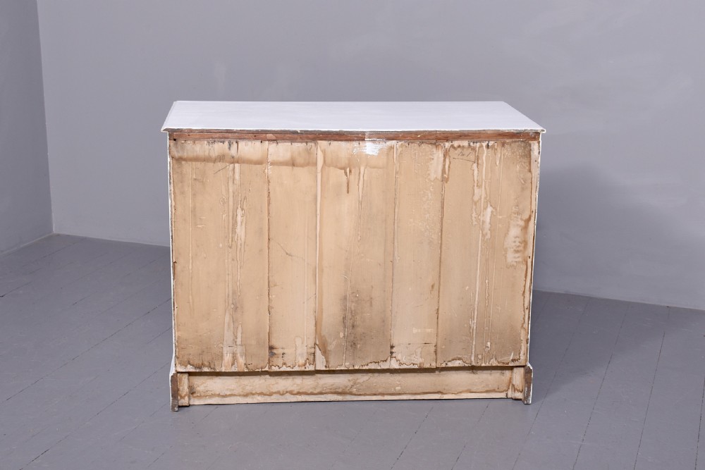 A Victorian ash chest of drawers painted in a pale Swedish grey finish, featuring a two-over-two drawer layout and brass drop handles. View II