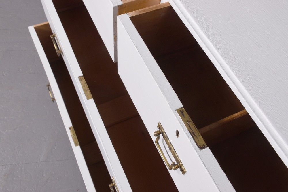 A Victorian ash chest of drawers painted in a pale Swedish grey finish, featuring a two-over-two drawer layout and brass drop handles. View III