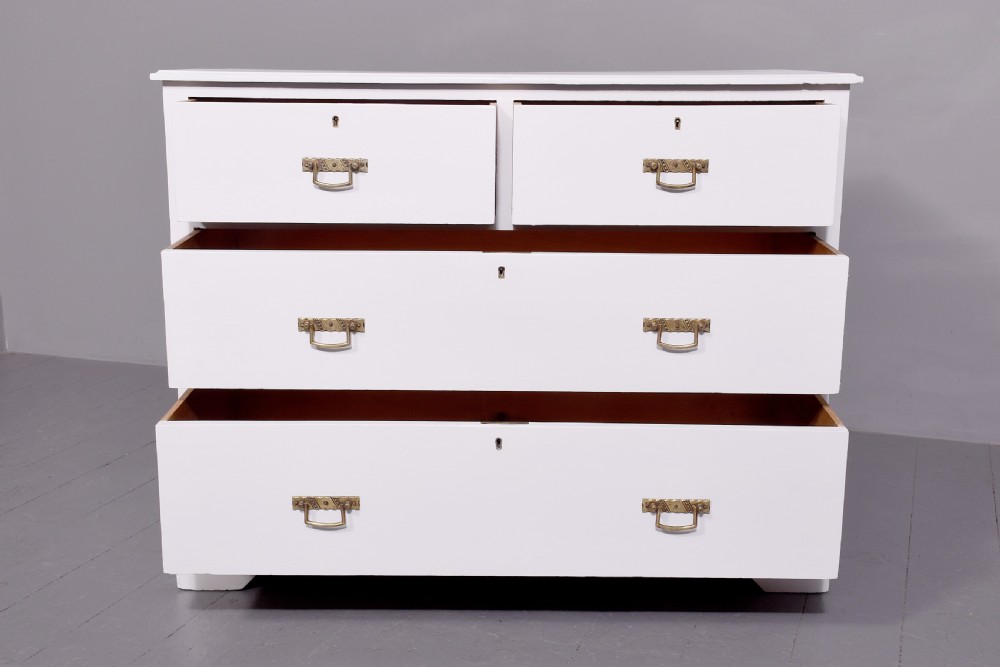 A Victorian ash chest of drawers painted in a pale Swedish grey finish, featuring a two-over-two drawer layout and brass drop handles. View IV