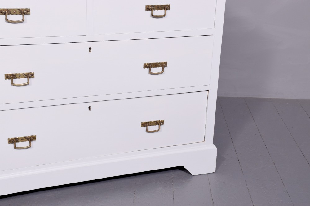 A Victorian ash chest of drawers painted in a pale Swedish grey finish, featuring a two-over-two drawer layout and brass drop handles. View VI