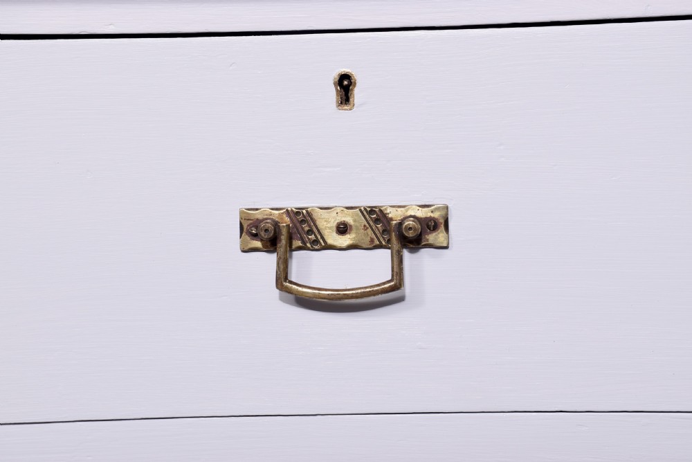 A Victorian ash chest of drawers painted in a pale Swedish grey finish, featuring a two-over-two drawer layout and brass drop handles. View VII