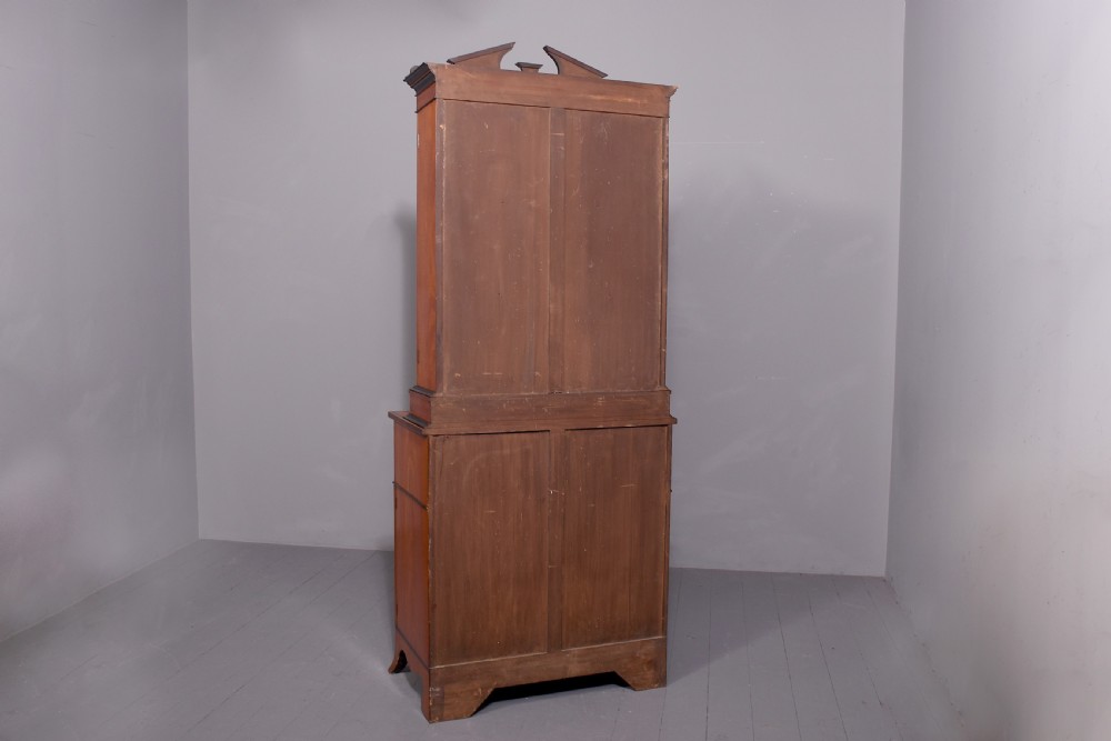 An antique satinwood secretaire bookcase featuring glazed upper doors with astragal tracery, detailed floral marquetry inlays, and an arched pediment. View VII