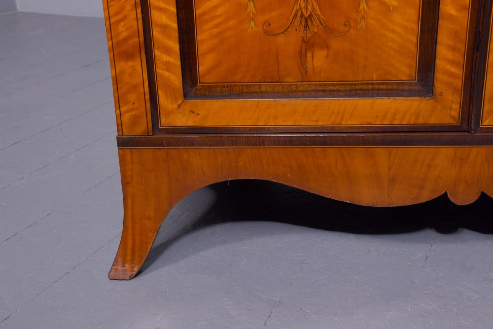 An antique satinwood secretaire bookcase featuring glazed upper doors with astragal tracery, detailed floral marquetry inlays, and an arched pediment. View VIII