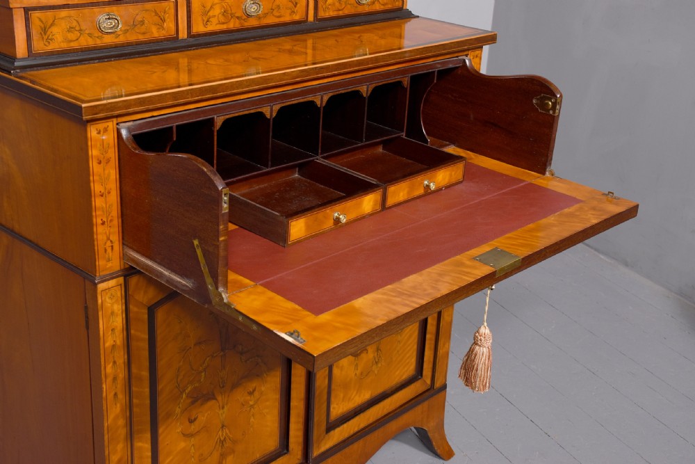 An antique satinwood secretaire bookcase featuring glazed upper doors with astragal tracery, detailed floral marquetry inlays, and an arched pediment. View XIII