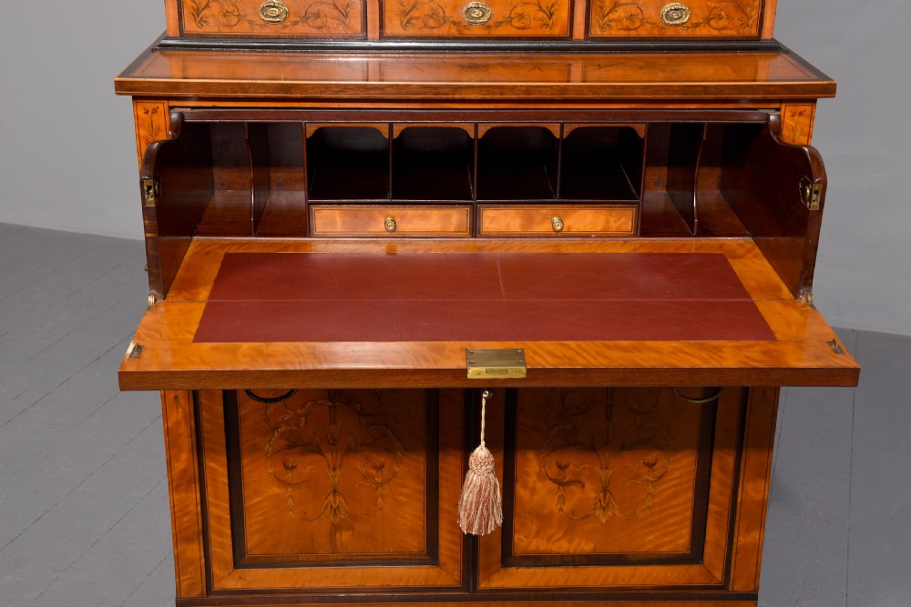 An antique satinwood secretaire bookcase featuring glazed upper doors with astragal tracery, detailed floral marquetry inlays, and an arched pediment. View XIV