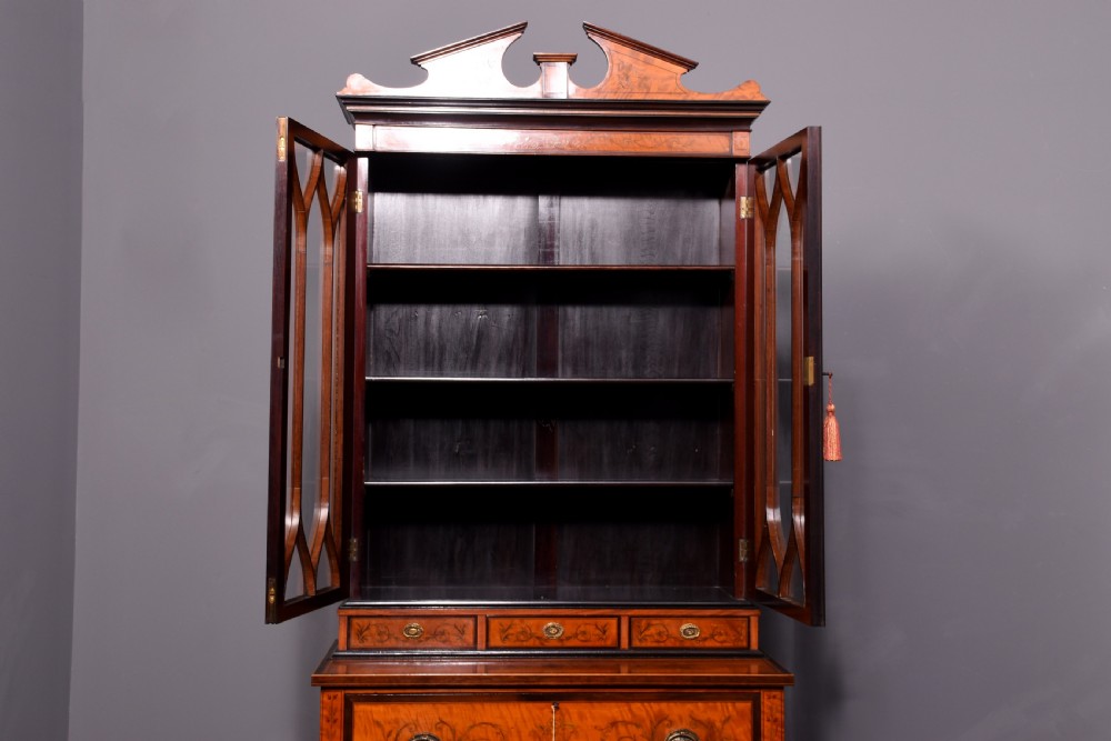 An antique satinwood secretaire bookcase featuring glazed upper doors with astragal tracery, detailed floral marquetry inlays, and an arched pediment. View XV