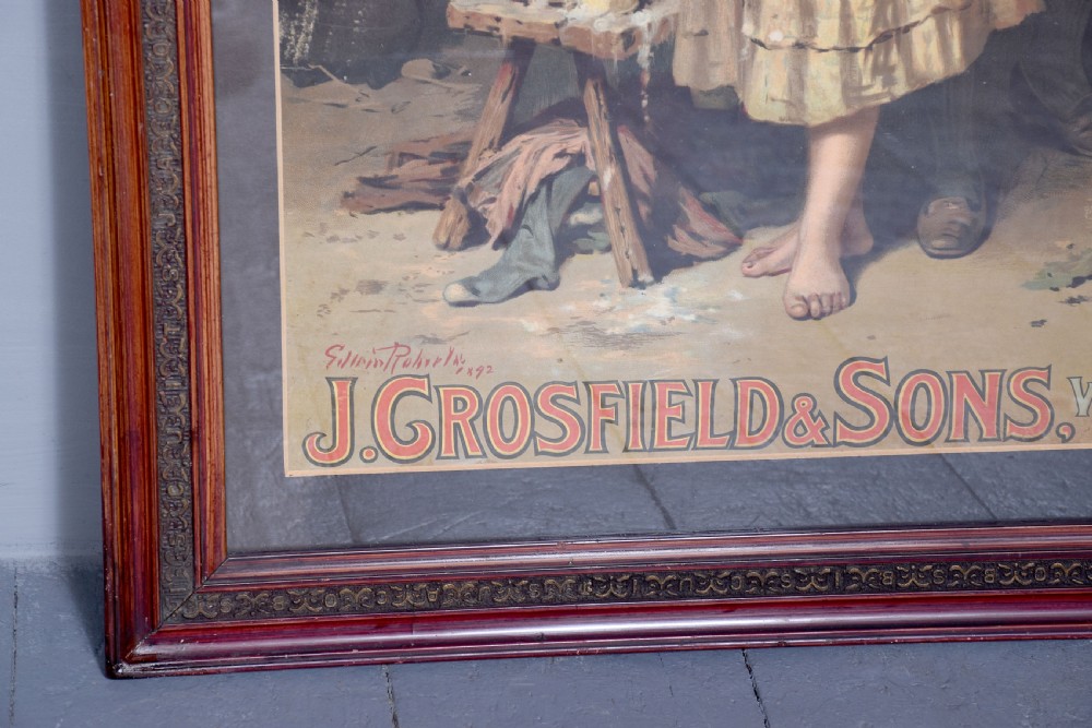 A framed Edwardian pictorial advertising poster for Perfection Soap depicting a man and woman in a rustic setting within a moulded dark wood frame. View IV