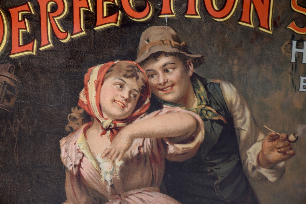 A framed Edwardian pictorial advertising poster for Perfection Soap depicting a man and woman in a rustic setting within a moulded dark wood frame. View V