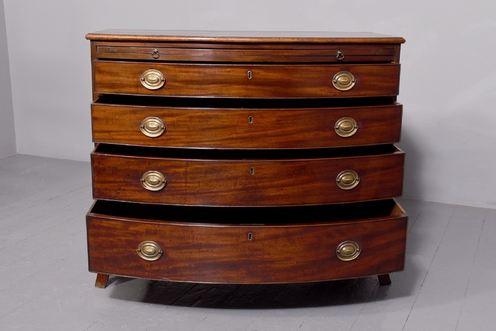 Neat size George 3rd mahogany bow - front chest of drawers with brushing slide and great colour and patina View V