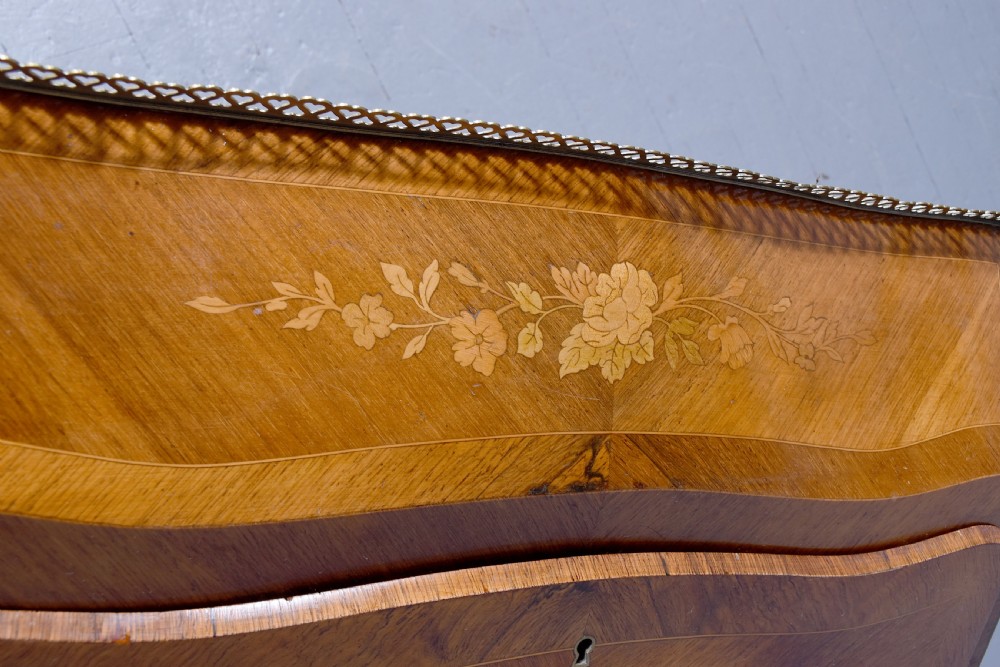 A small French Louis XV style slope-front writing desk featuring floral marquetry inlays, cabriole legs with brass mounts, and a brass gallery rail. View II