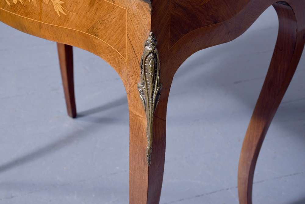 A small French Louis XV style slope-front writing desk featuring floral marquetry inlays, cabriole legs with brass mounts, and a brass gallery rail. View VII