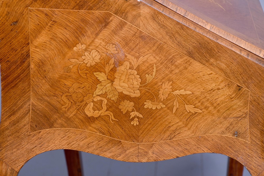 A small French Louis XV style slope-front writing desk featuring floral marquetry inlays, cabriole legs with brass mounts, and a brass gallery rail. View VIII