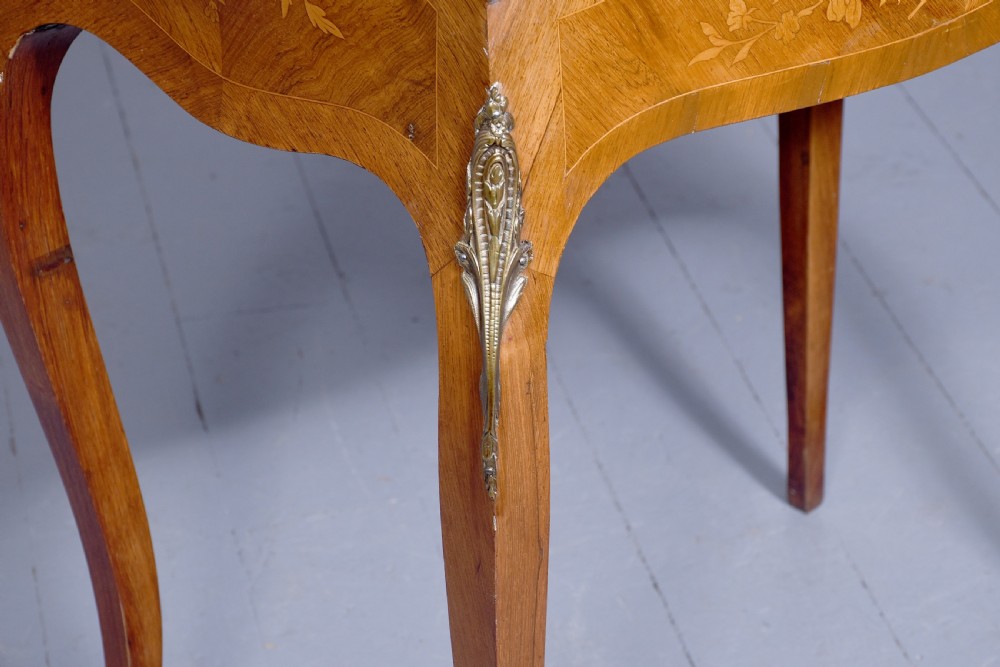 A small French Louis XV style slope-front writing desk featuring floral marquetry inlays, cabriole legs with brass mounts, and a brass gallery rail. View XVIII