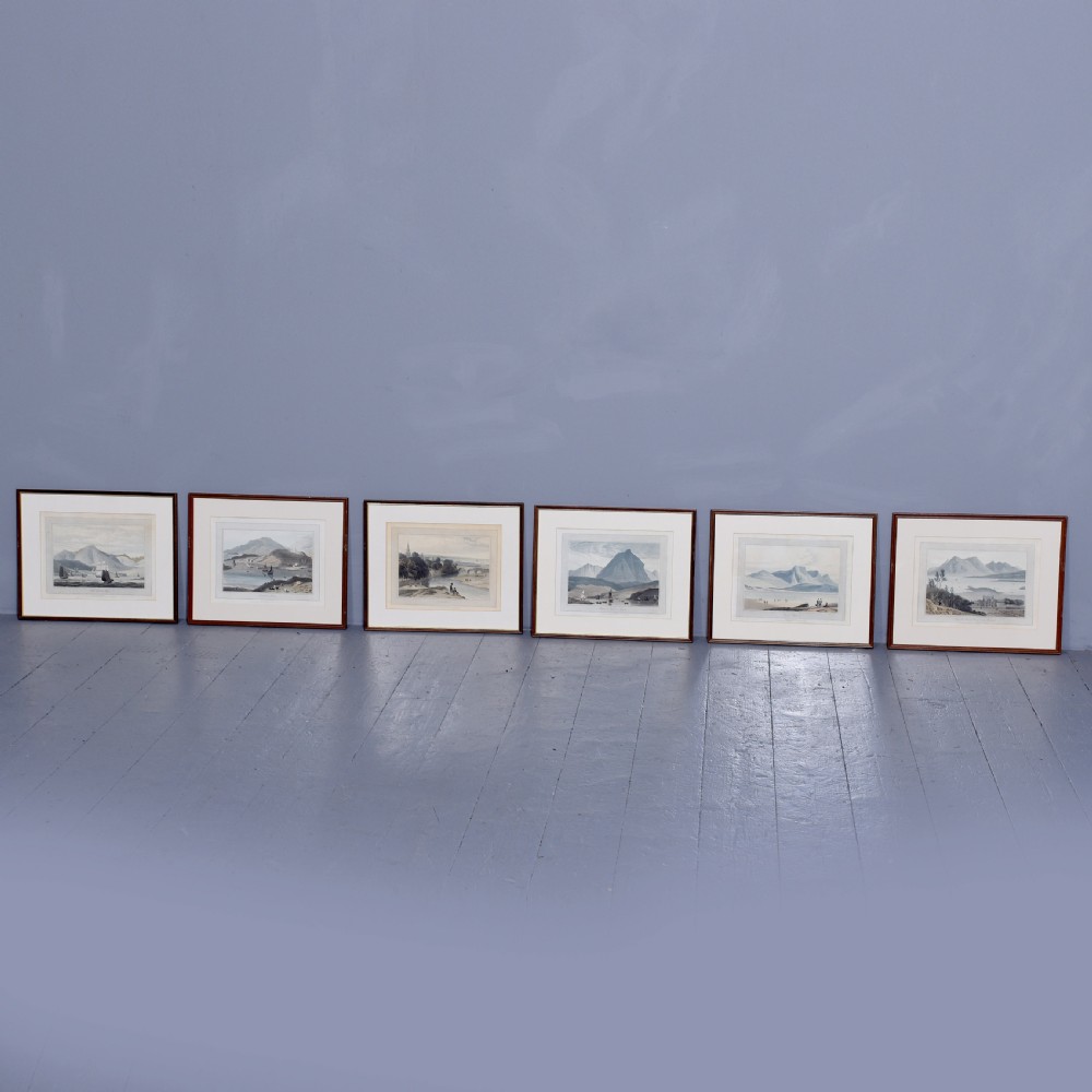 A row of six framed antique Regency landscape prints featuring topographical scenes framed in brown wood with cream mounts.