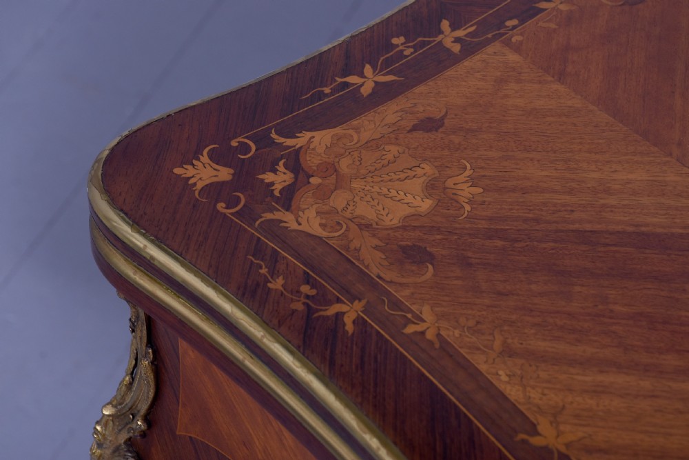 A Louis XV style French fold-over card table featuring warm brown veneer with floral marquetry inlay, cabriole legs, and gilt-bronze mounts. View XIV