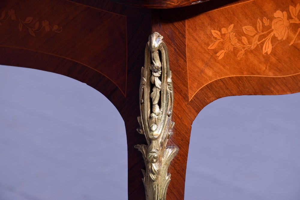 A Louis XV style French fold-over card table featuring warm brown veneer with floral marquetry inlay, cabriole legs, and gilt-bronze mounts. View XVI