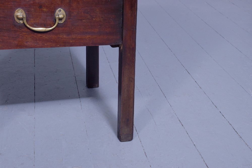 A George III mahogany tray top bedside commode featuring a raised gallery with handles, two cupboard doors, and a lower drawer with a brass bail handle. View VI