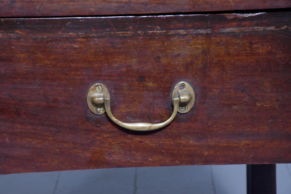 A George III mahogany tray top bedside commode featuring a raised gallery with handles, two cupboard doors, and a lower drawer with a brass bail handle. View VII