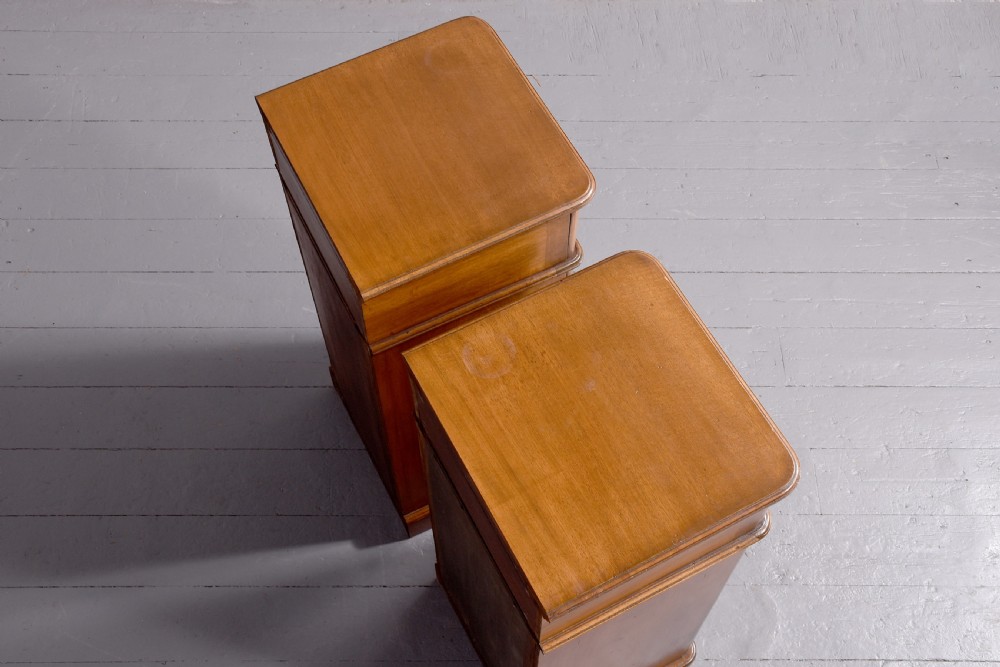 A pair of tall Victorian mahogany Wellington-style chests, each featuring five stacked drawers with turned wood knobs and stepped plinth bases. View IV