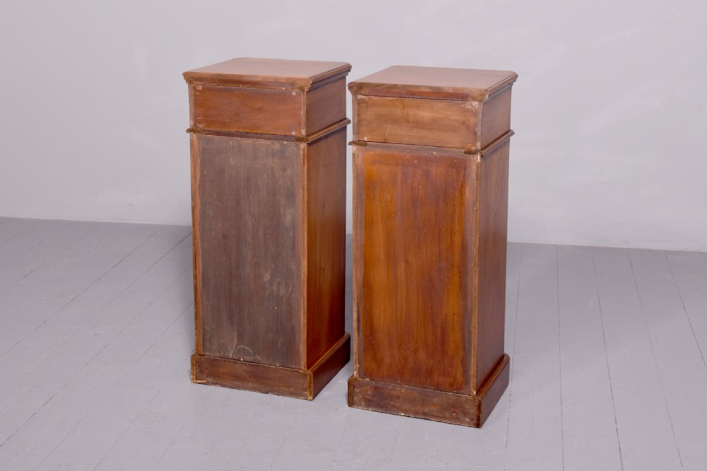 A pair of tall Victorian mahogany Wellington-style chests, each featuring five stacked drawers with turned wood knobs and stepped plinth bases. View VIII
