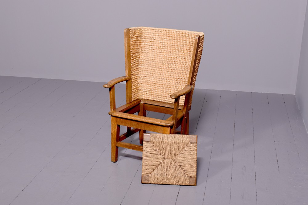 An oak armchair featuring a tall woven straw backrest, flat open armrests, and a rush seat. View VI