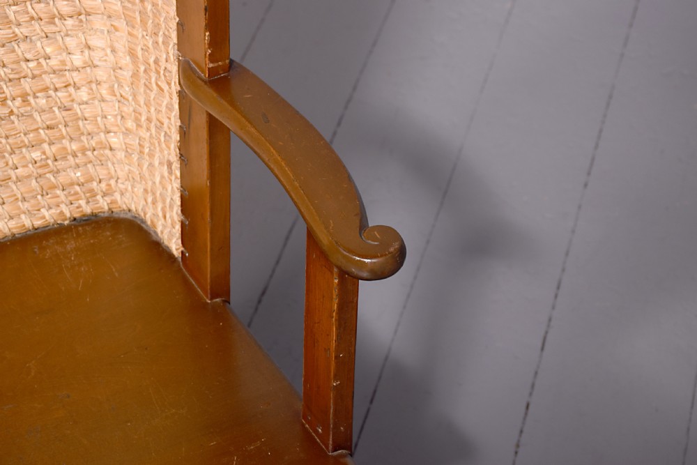 A stained beech wood armchair featuring a high curved backrest hand-woven from natural straw, a flat wooden seat, and open armrests. View II