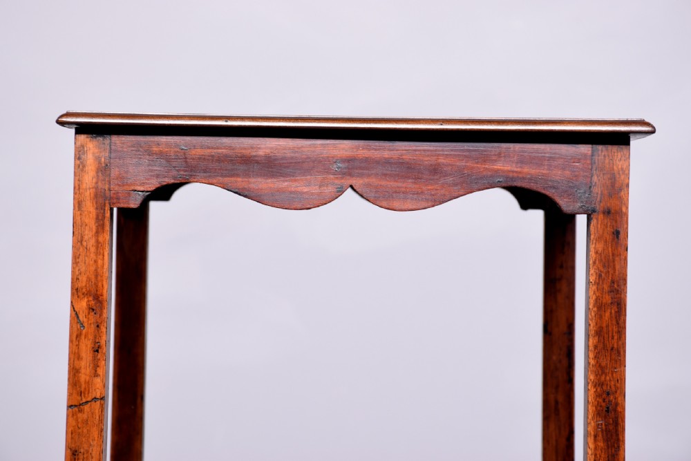 A square two-tier mahogany occasional table featuring slender uprights, a scalloped frieze detail, and a cross-stretcher base. View III