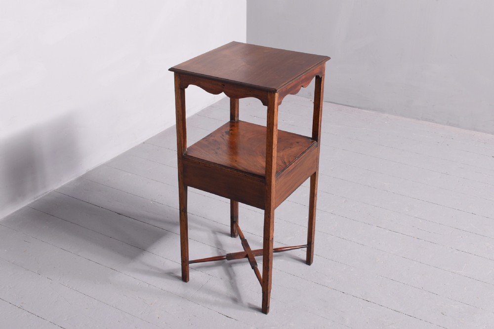 A square two-tier mahogany occasional table featuring slender uprights, a scalloped frieze detail, and a cross-stretcher base. View VII