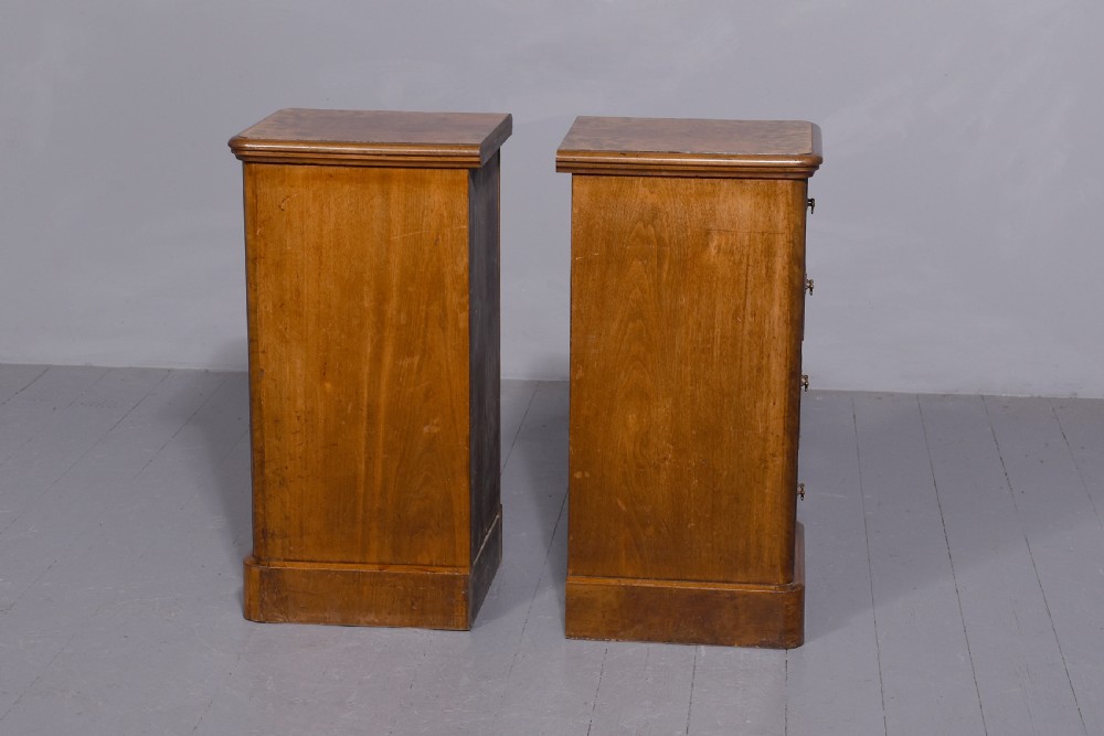 A pair of late Victorian burr walnut small chests of drawers featuring four drawers each with brass handles and plinth bases. View III