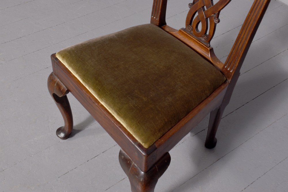 A George II carved mahogany side chair featuring a pierced strapwork splat back, green velvet seat, and cabriole front legs with pad feet. View III