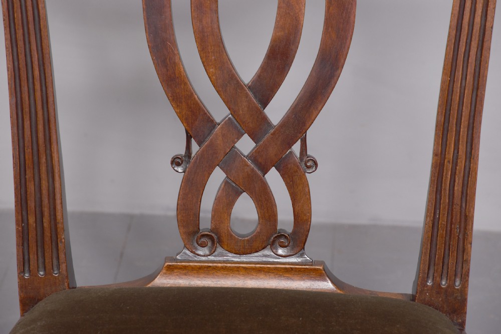 A George II carved mahogany side chair featuring a pierced strapwork splat back, green velvet seat, and cabriole front legs with pad feet. View V