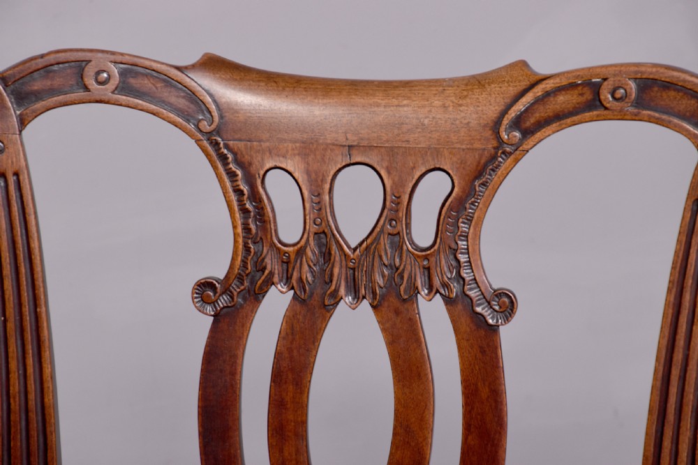 A George II carved mahogany side chair featuring a pierced strapwork splat back, green velvet seat, and cabriole front legs with pad feet. View VII
