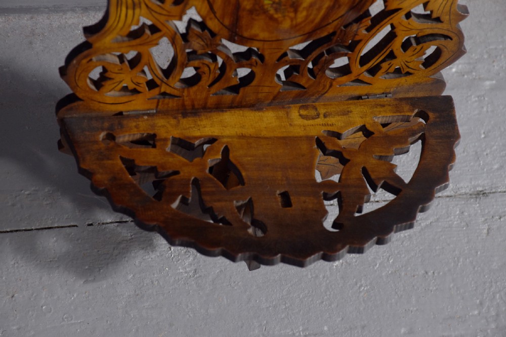 A pair of carved brown wooden wall brackets featuring pierced fretwork, foliage motifs, and oval central panels with painted floral designs. View III