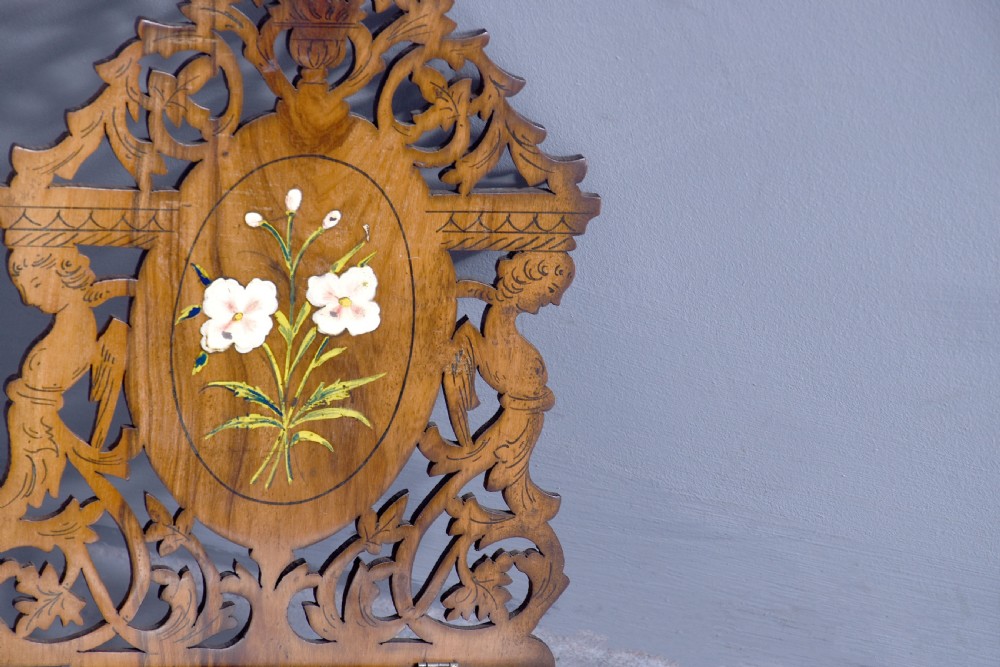 A pair of carved brown wooden wall brackets featuring pierced fretwork, foliage motifs, and oval central panels with painted floral designs. View IX